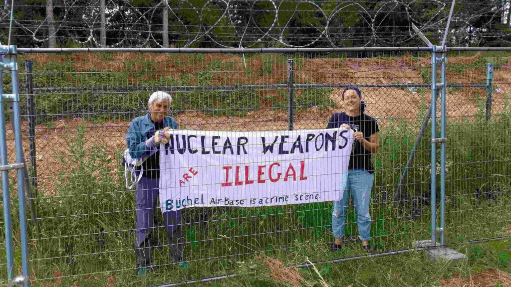 The banner of Susan Crane and Magriet Bos of the Treaty Enforcment Action activists explains why they have entered the Buechel Air Force Base.