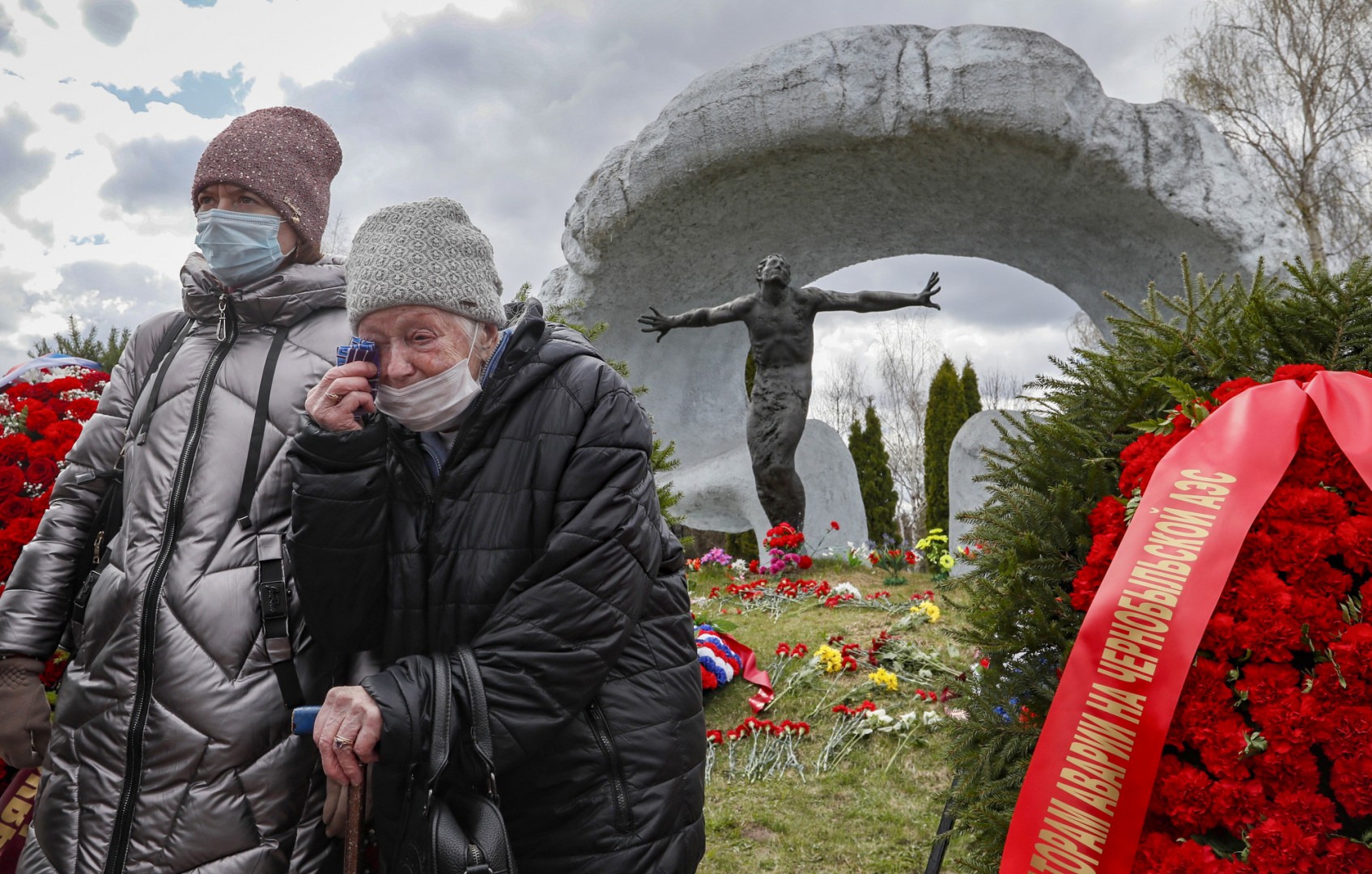Women mourn near a tomb of a victim of the Chernobyl nuclear power plant disaster at the Mitino cemetery in Moscow...